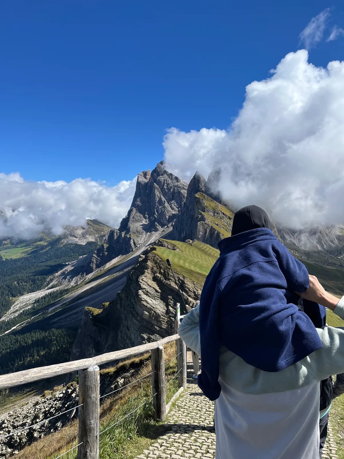 Hiking along a ridge at Seceda with jagged Dolomite peaks ahead