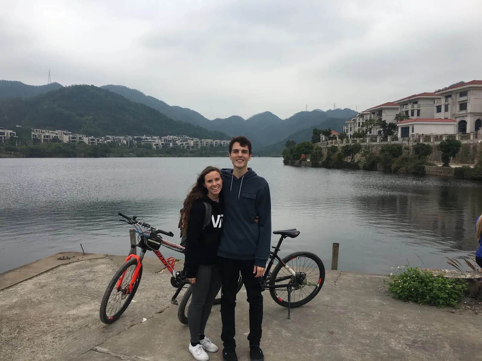 Nick and a companion with bikes beside a lake